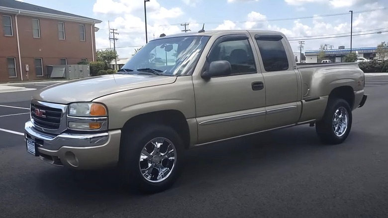 Light gold 2004 GMC Sierra parked