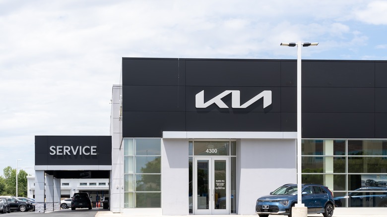 White Kia Logo on a dealership building exterior