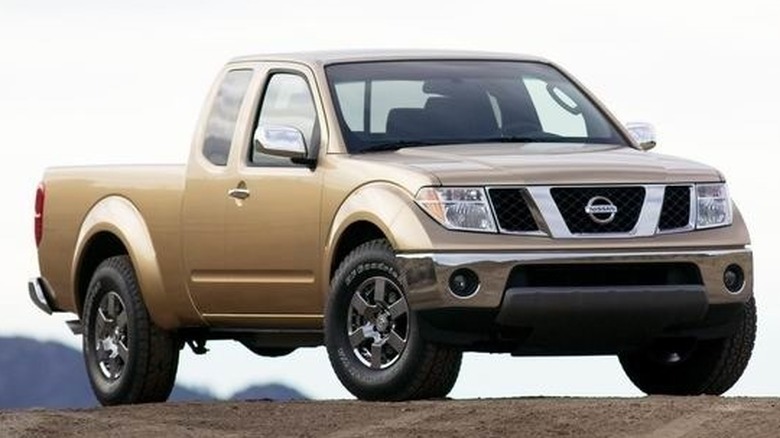 Bronze 2005 Nissan Frontier on dirt road