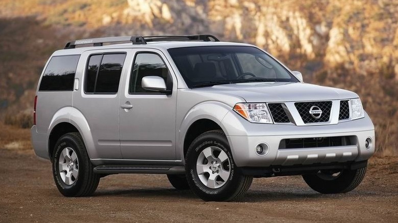 Silver 2005 Nissan Pathfinder on dirt road