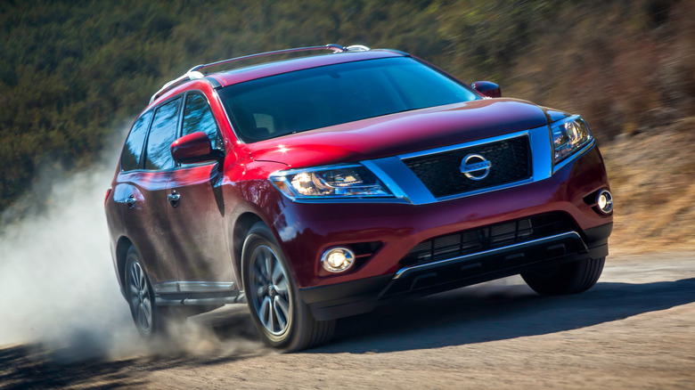 Red 2013 Nissan Pathfinder driving