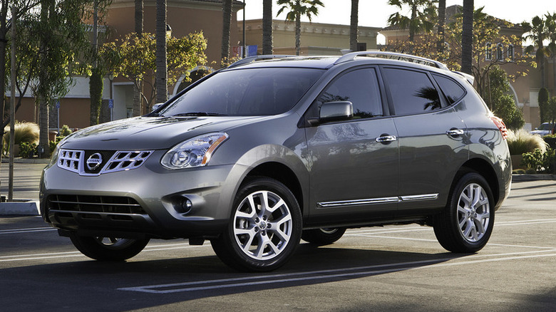 Silver 2013 Nissan Rogue parked