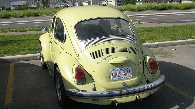 Yellow 1971 Volkswagen Super Beetle in a parking lot