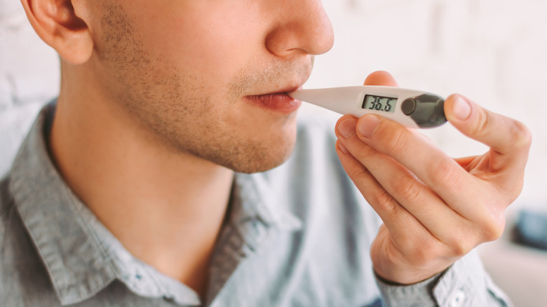 Man using thermometer