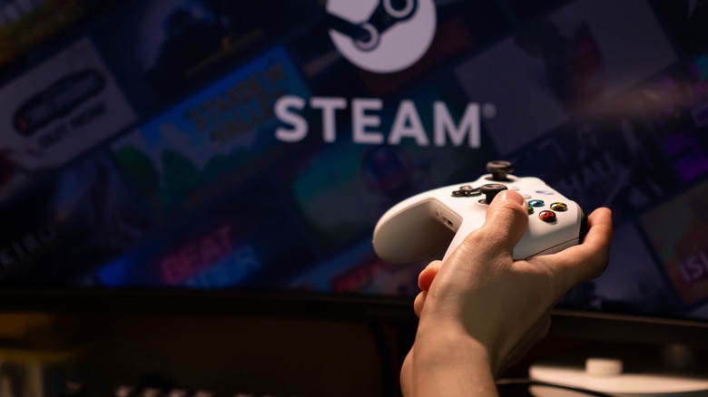 Controller held in front of Steam Logo