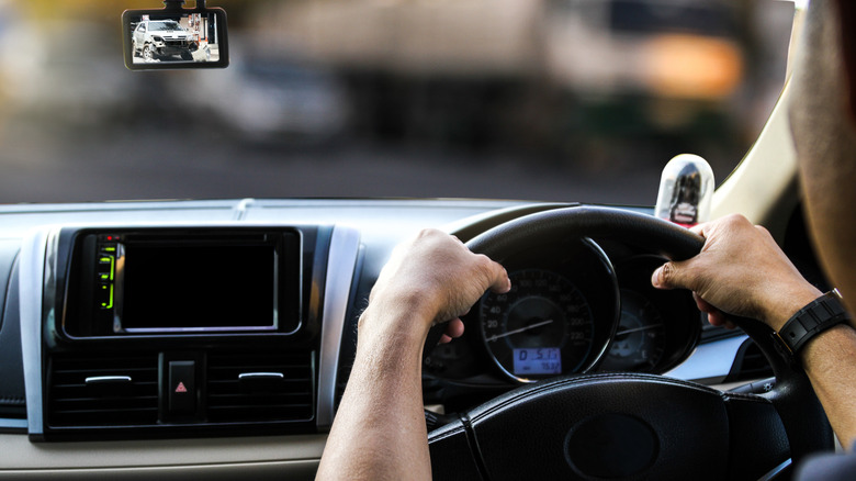 A driver is using their smartphone as a dash cam 