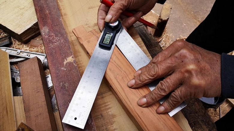 metal digital angle finder on wood