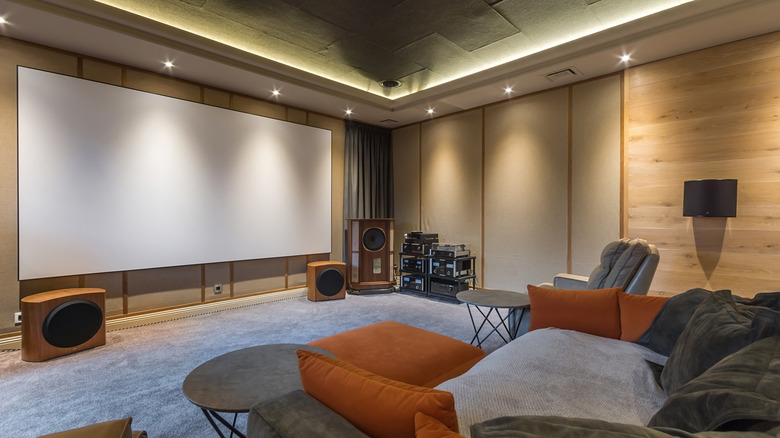 Home theater setup with furniture and large screen