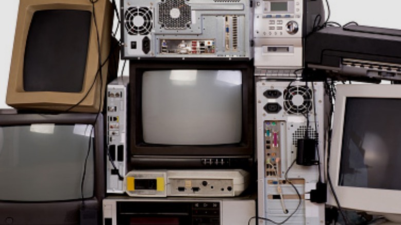 stack of old computers and tvs