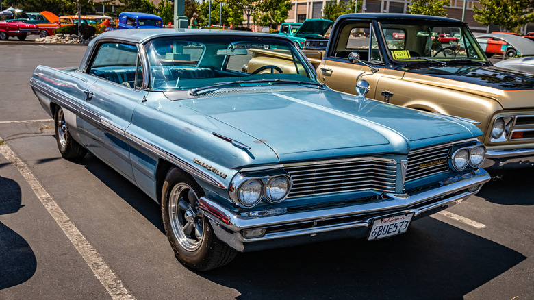 A blue 1962 Pontiac Bonneville in a parking lot