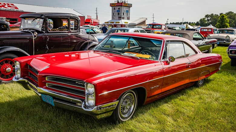 A red Pontiac Ventura at an auto show