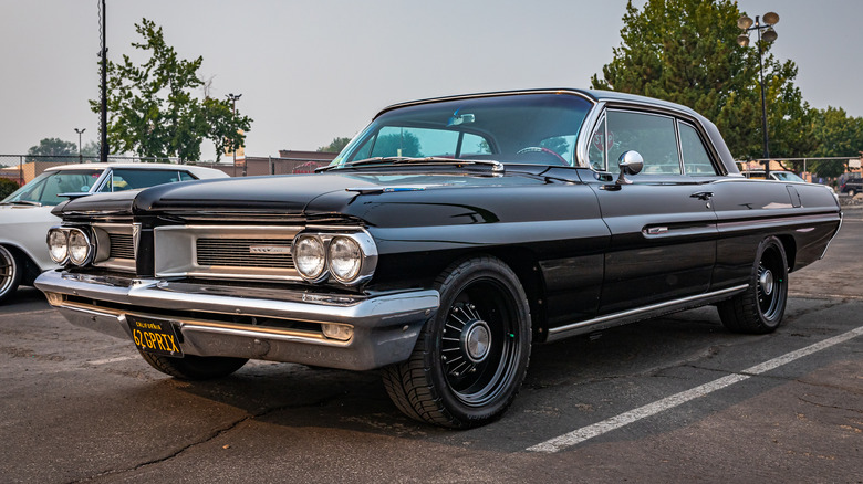 A 1962 Pontiac Grand Prix in a parking lot