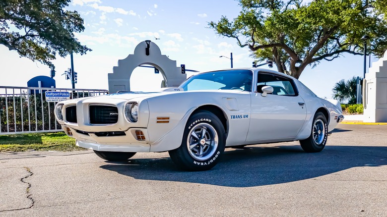 A white 1973 Pontiac Trans Am at an auto show