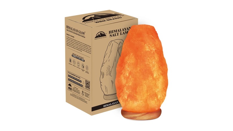 Orange glowing lamp resembling rock salt next to a cardboard box