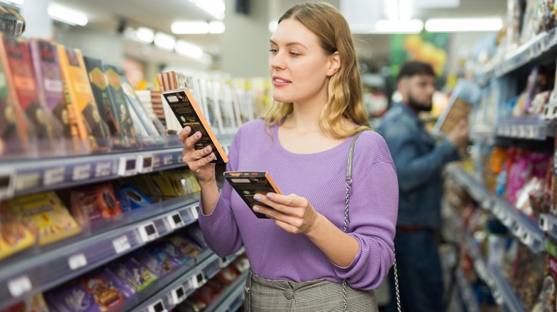 woman investigating two similar products