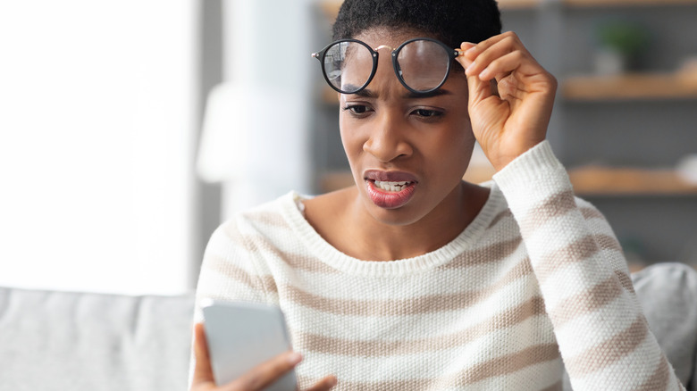 woman making sense of phone screen