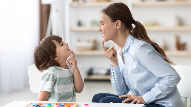 woman teaching child pronunciation