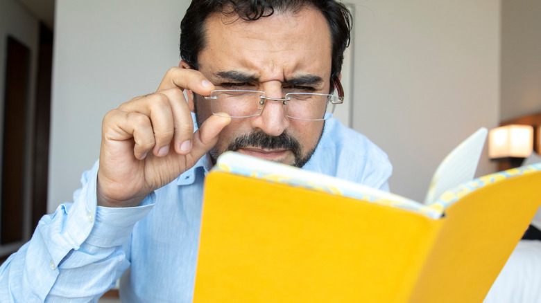 man reading small notes