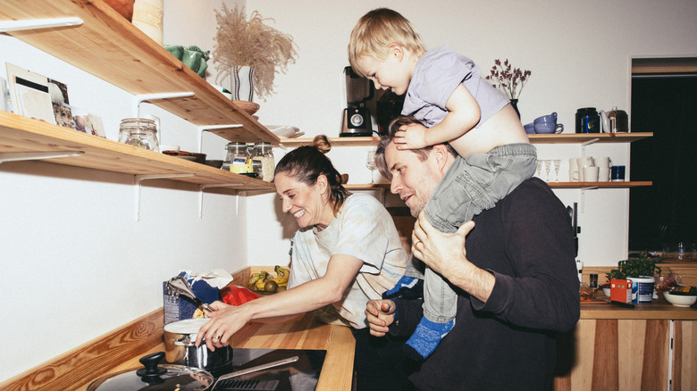 family cooking together in kitchen