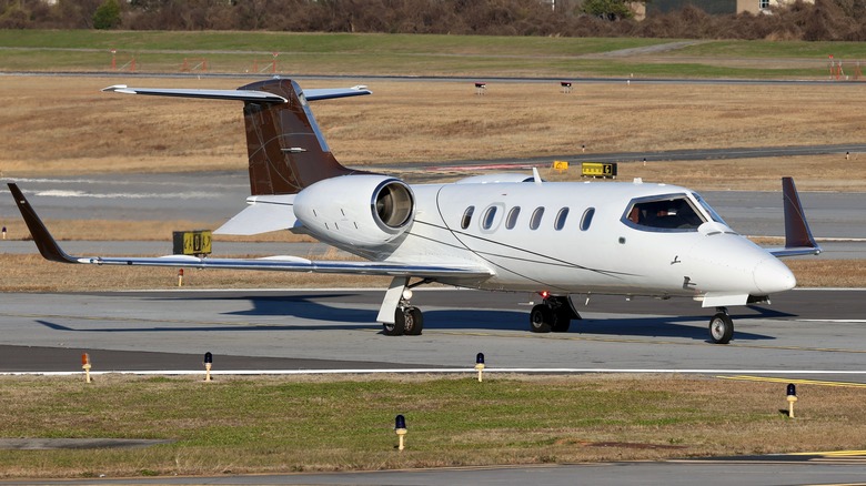 Learjet taxiing at airport