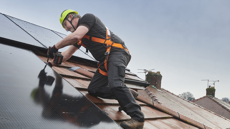 Man using safety harness on roof