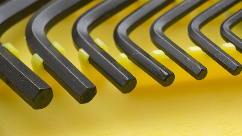 Series of black hex keys on a yellow holder display