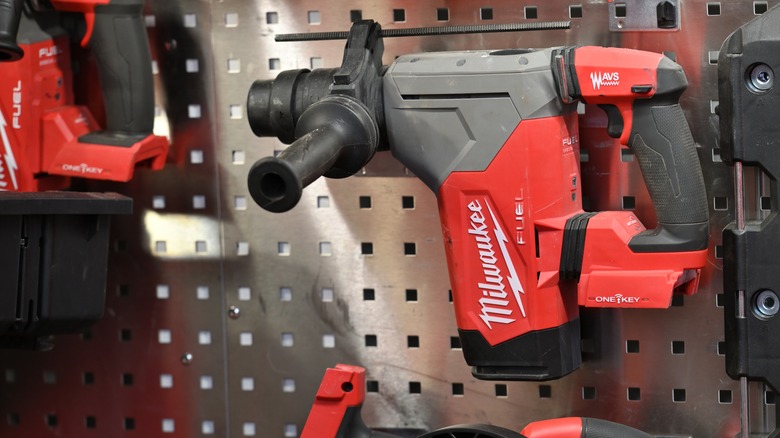 Red and black Milwaukee power tool on a pegboard display