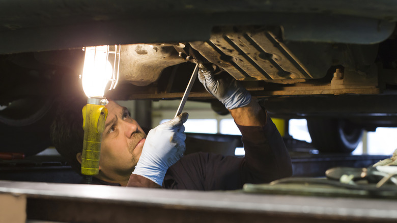 mechanic working with an old-style hook light