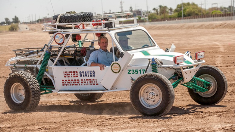 Then-President Geroge W. Bush in a U.S. Border Patrol dune buggy in 2006