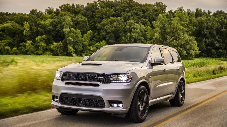 a silver Dodge Durango SUV driving down a road