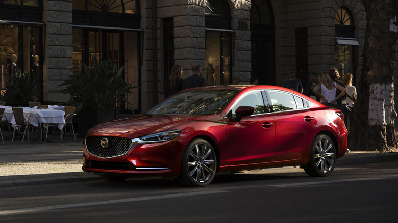 Red Mazda 6 parked on a street front 3/4 view