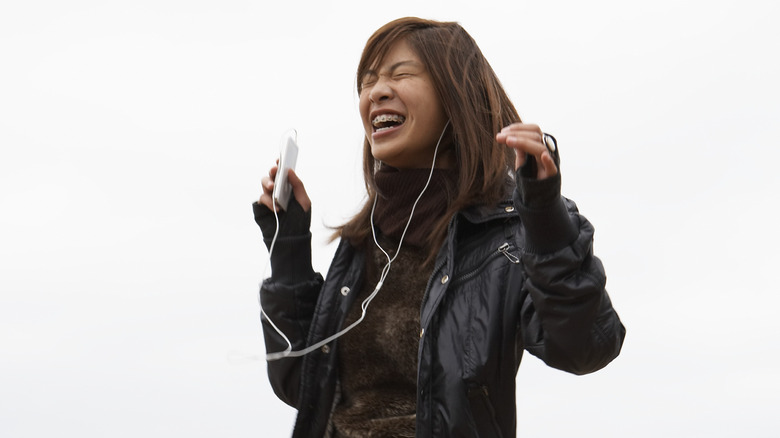 woman dancing with headphones