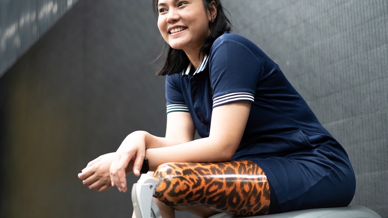 woman with a prosthetic leg smiling