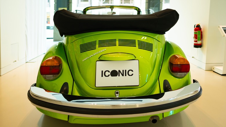 The back end of a lime green VW Beetle convertible