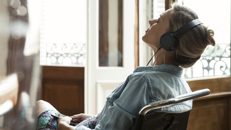 sitting woman listening to music