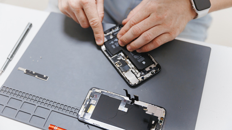 a technician fixing an iPhones 'issue'