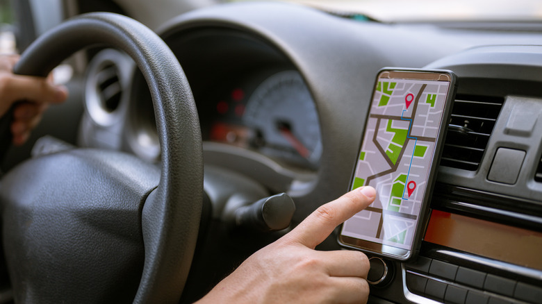 man using phone in car