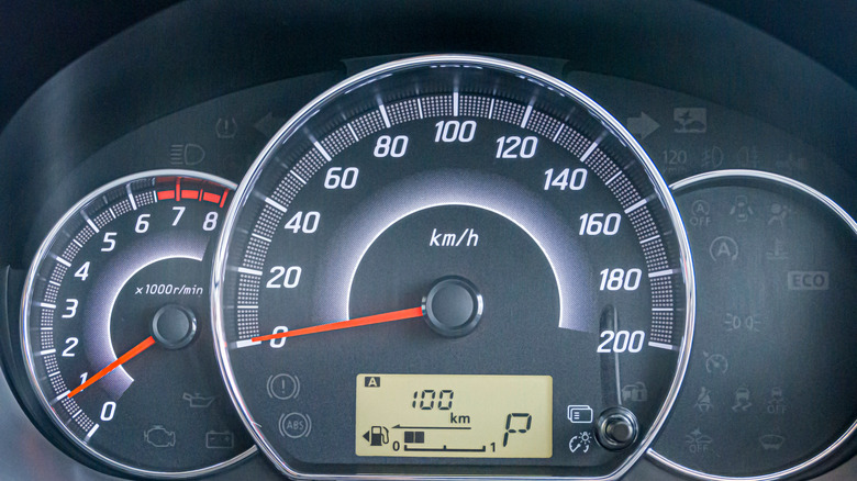 a car's dashboard displaying the speedometer and tachometer