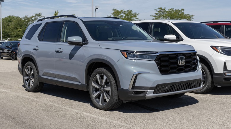 A gray Honda Pilot in a parking lot