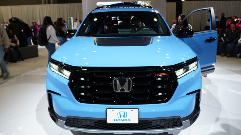 Blue Honda pilot on a showroom floor