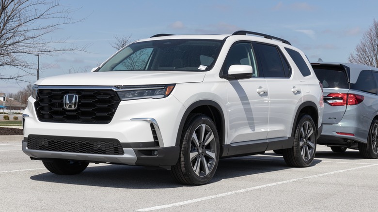 A white Honda Pilot in a parking lot