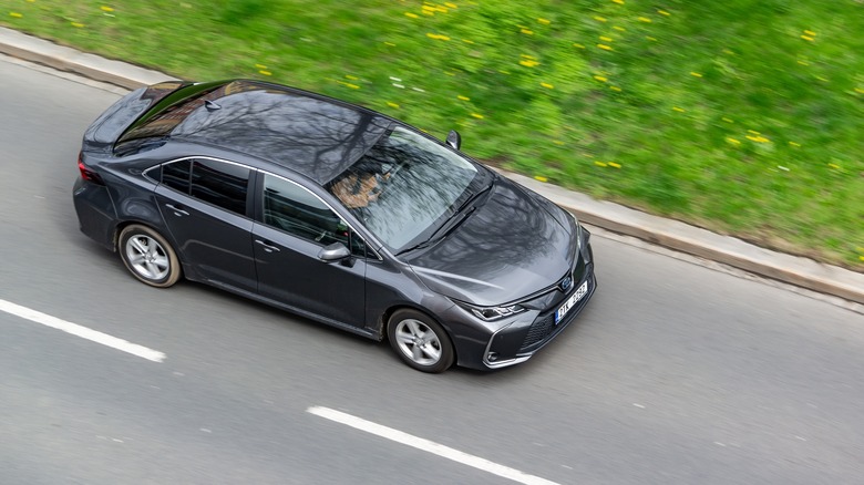 Toyota Corolla driving down road