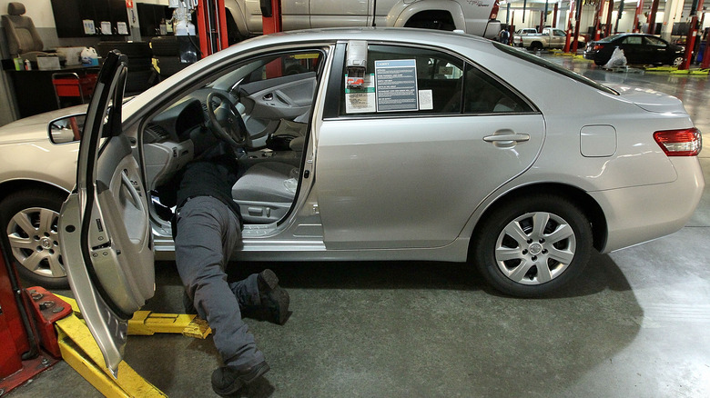 Mechanic works on Toyota Corolla