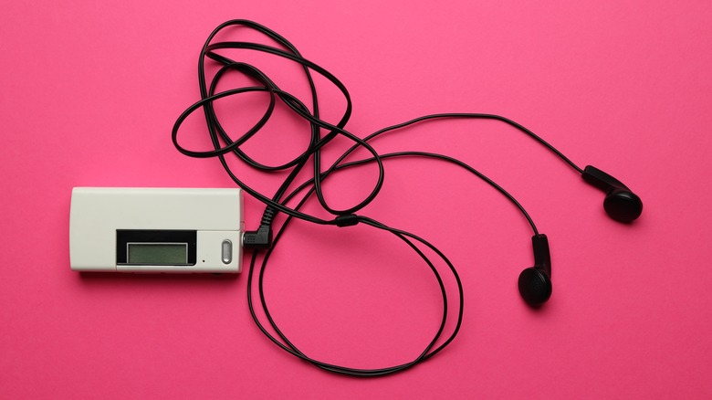 Vintage MP3 player on pink background.