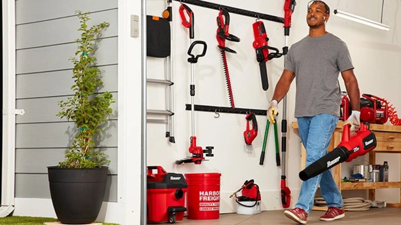 man walking out of garage with Bauer tools