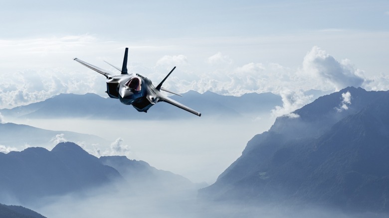 An f-35 flying over the alps.