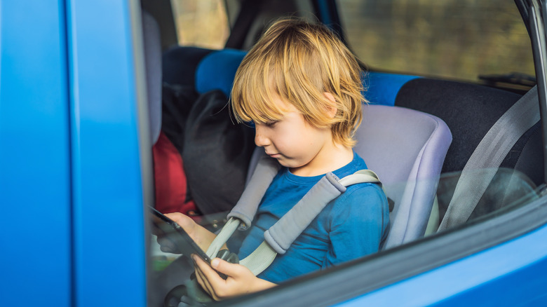 Kid uses iPad backseat