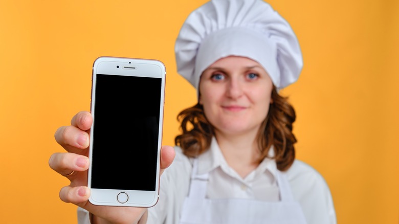 Chef holding iPhone