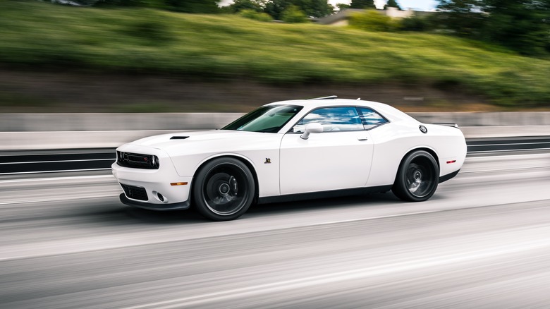 A white Dodge Charger on highway