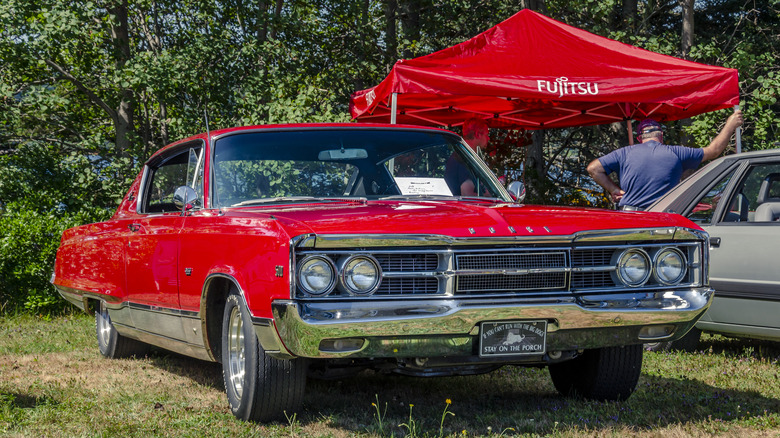 Dodge Monaco parked near tent